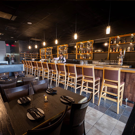 Dining tables and bar seating inside The Blend Kitchen + Bar in Hinton